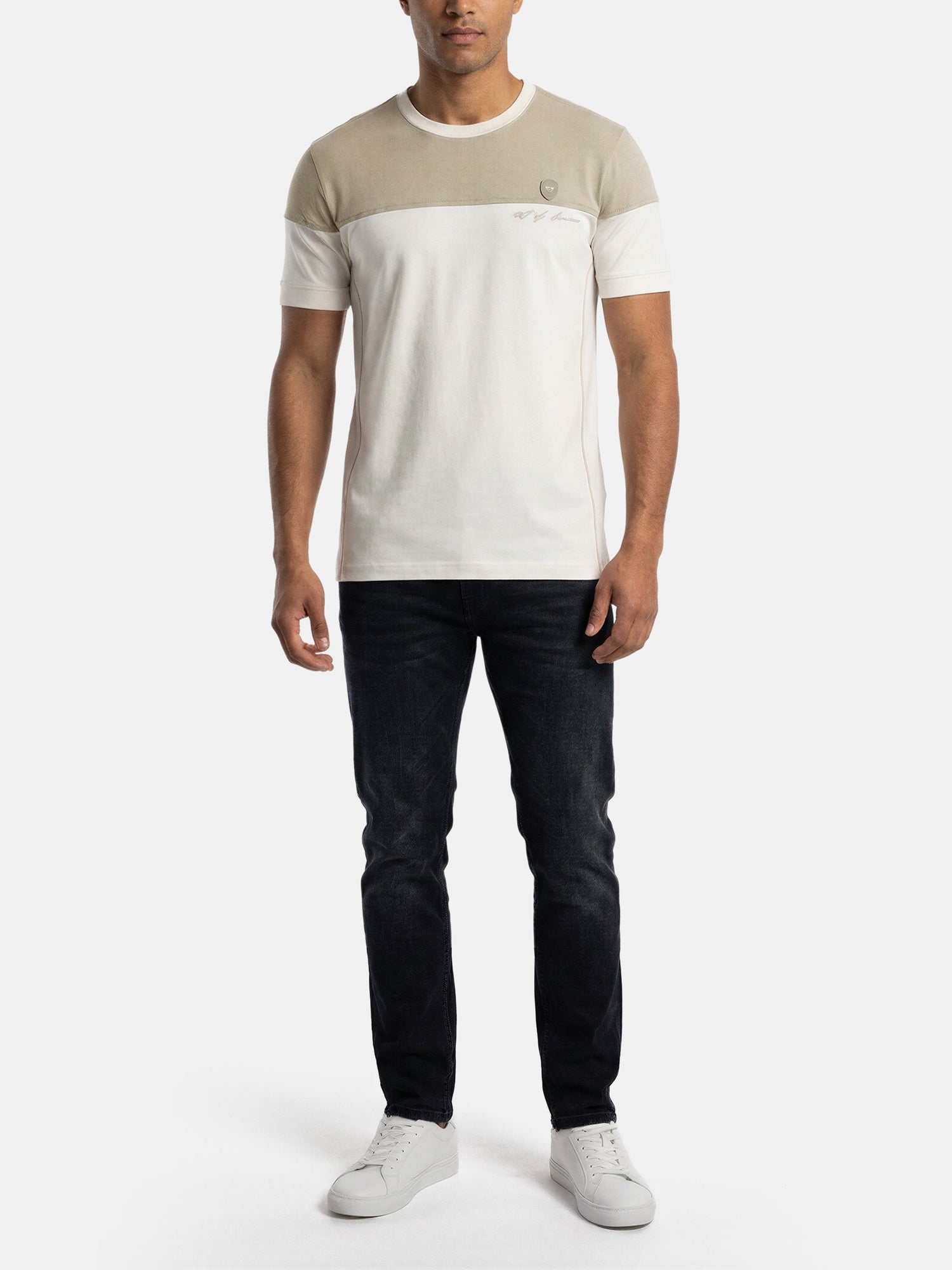 Model wearing off-white men’s T-shirt with beige chest panel, styled with dark jeans