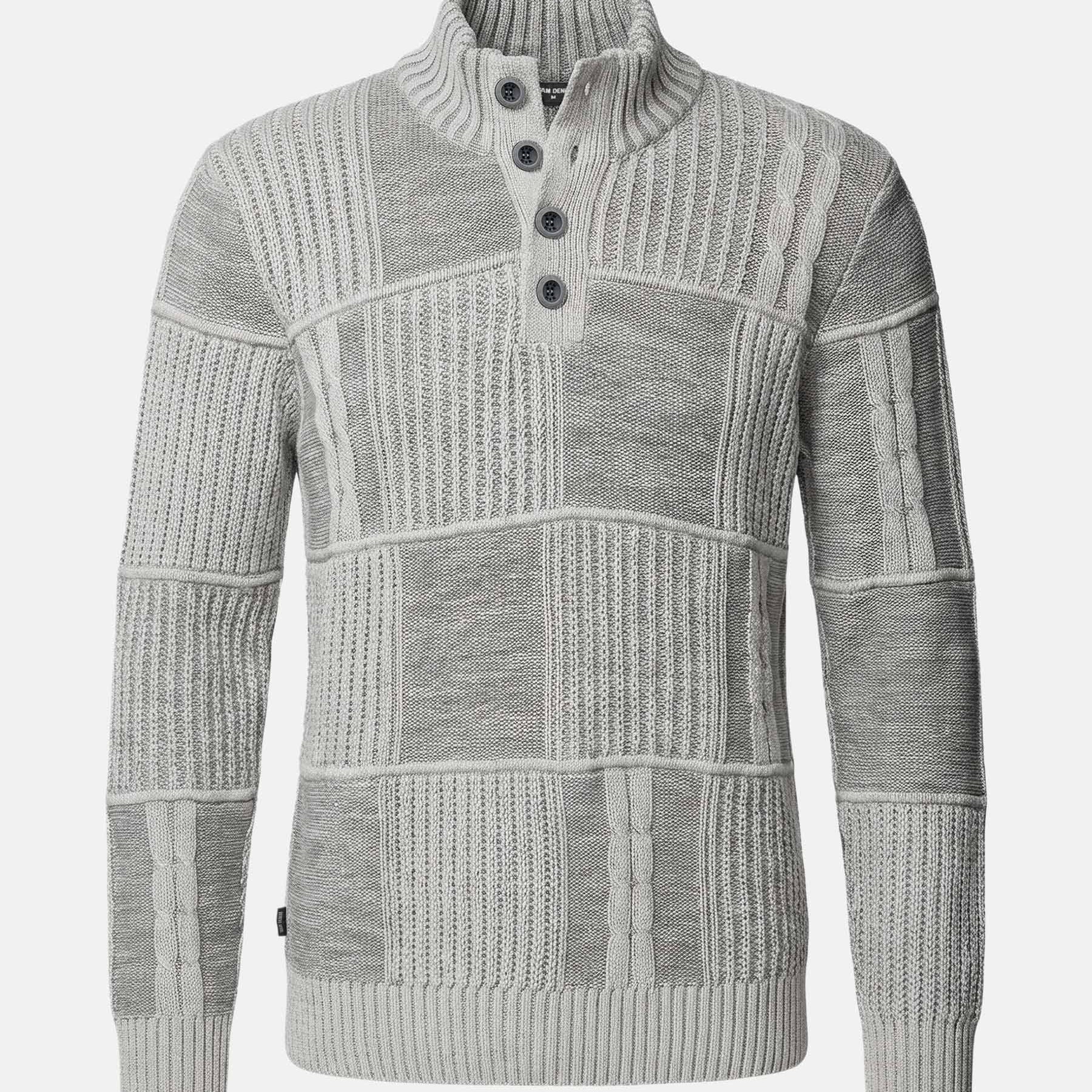 Light grey men’s knitwear sweater with textured patchwork design and buttoned high collar.