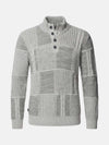 Light grey men’s knitwear sweater with textured patchwork design and buttoned high collar.