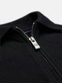 Close-up of black zip polo collar, textured cotton fabric detail for men