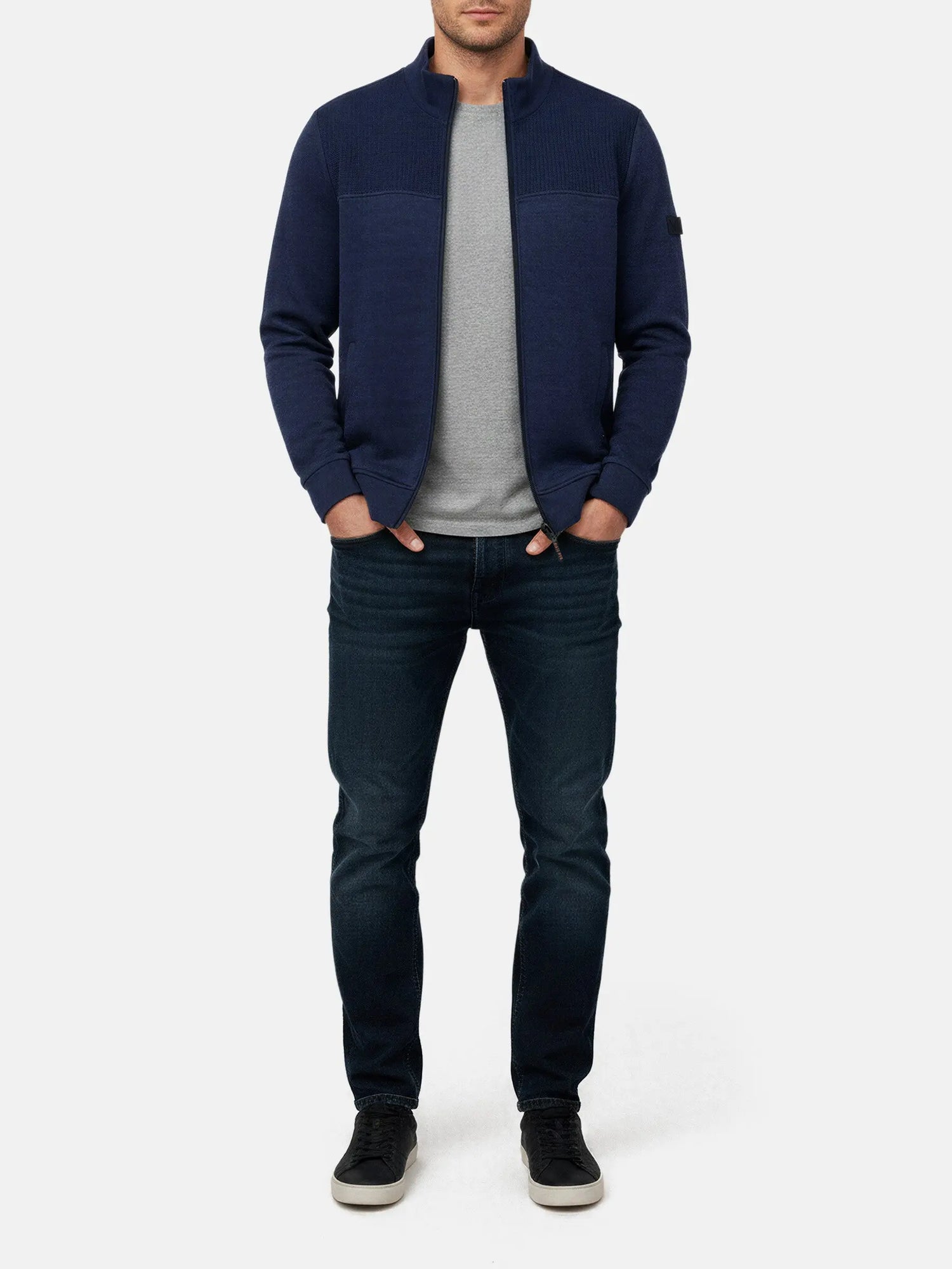 Model wearing Light Indigo full-zip men’s jacket with textured panel, styled with jeans.