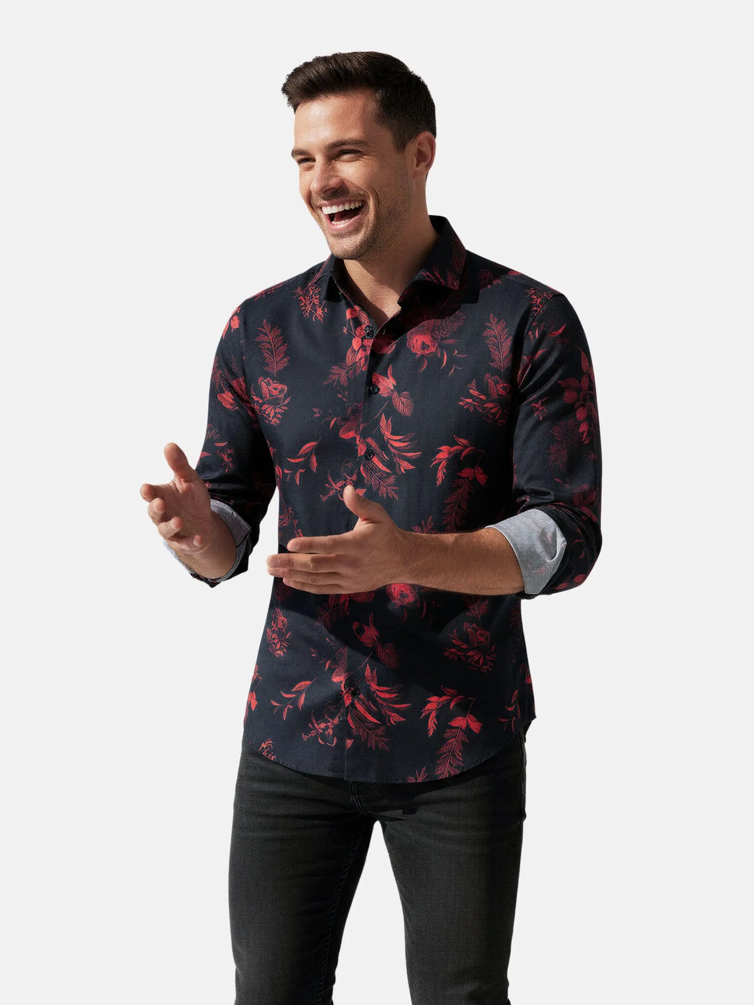 Close-up of black men’s shirt with detailed red floral print and black buttons.