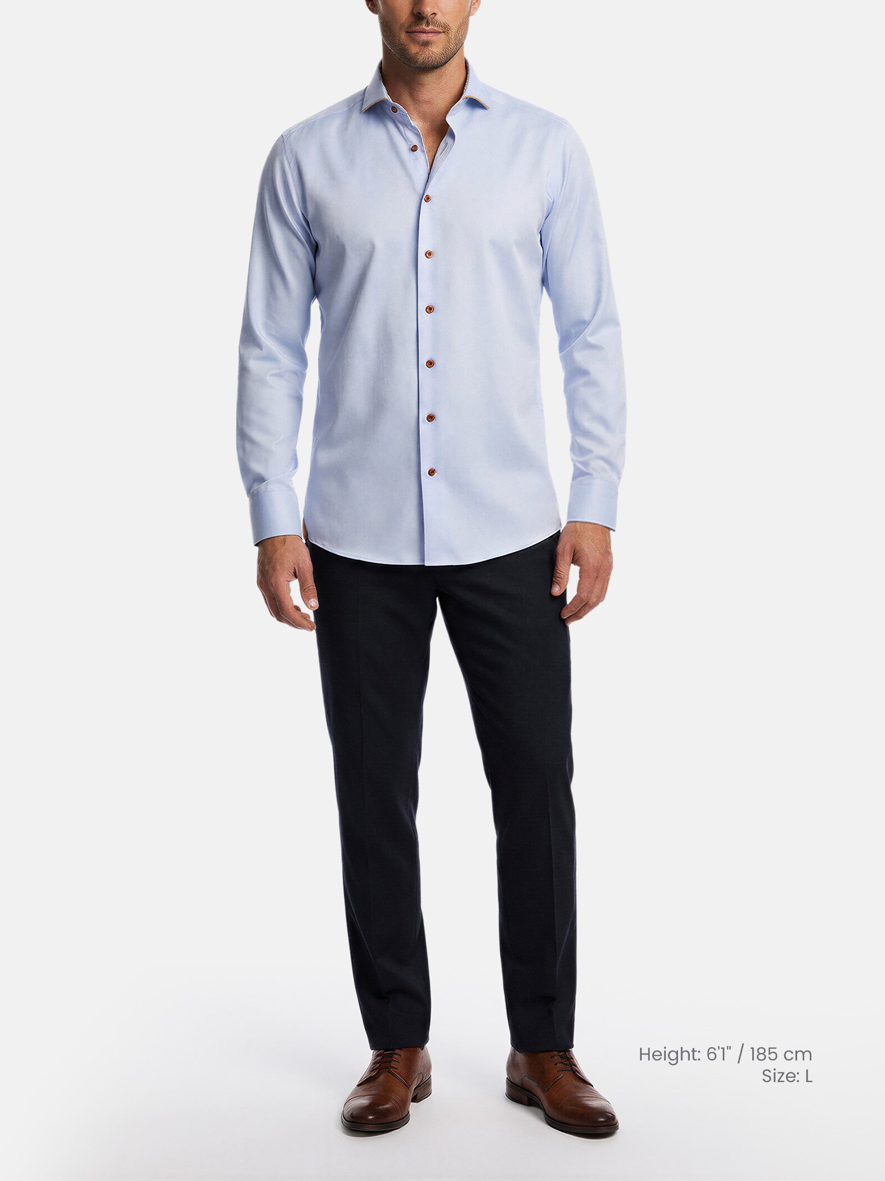 Model wearing light blue men’s dress shirt styled with black trousers and leather shoes