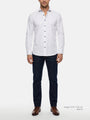 Model wearing white slim fit men’s dress shirt with dark buttons and jeans