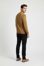 Back view of a male model wearing a Wam Denim dark-yellow crew-neck sweater