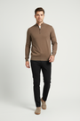 Male model in a walking pose wearing a Wam Denim brown quarter-zip knit sweater