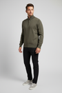 Male model wearing the Shrap khaki pullover in a three-quarter view