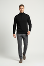 Male model in a walking pose wearing the Wam Denim Sharp black quarter-zip knit sweater