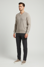 Male model wearing the Forge beige textured V-neck sweater in a three-quarter view
