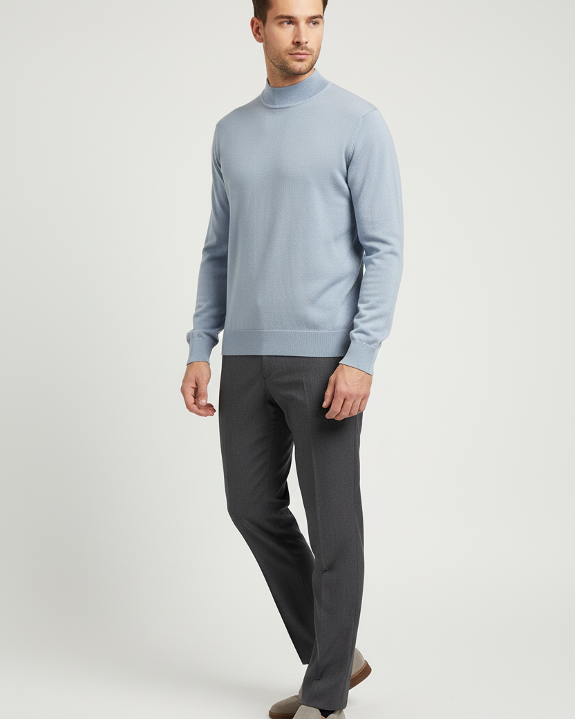 Male model wearing the Lux light-blue mock-neck sweater in a three-quarter view