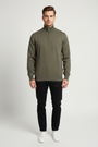Close view of the neckline, shoulder construction and texture of the Shrap khaki pullover