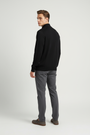 Back view of a male model wearing the Wam Denim Halron black quarter-zip sweater