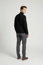 Back view of a male model wearing the Sharp black sweater with Wam Denim neck branding