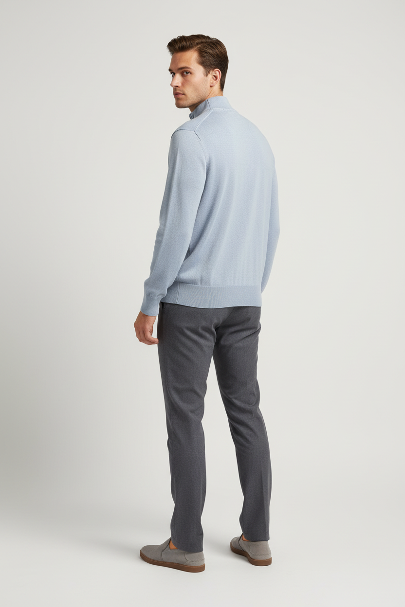 Back view of a male model wearing the Lux light-blue sweater with Wam Denim neck branding