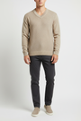 Close view of the ribbed V-neck and basket-weave front texture of the Forge beige sweater