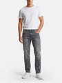 Model wearing slim-fit grey jeans styled with a white t-shirt and sneakers.