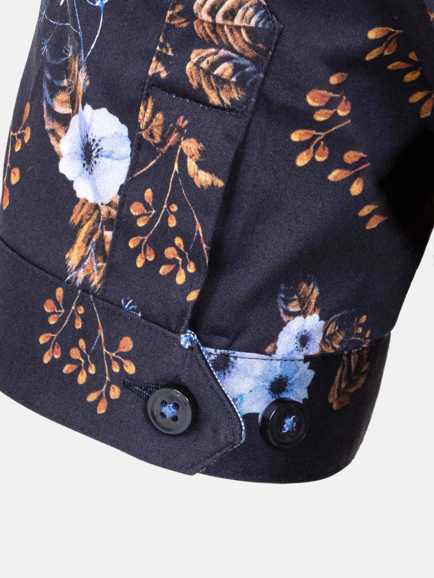 Close-up of navy floral shirt cuff with button and print detail