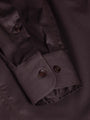Close-up of brown men’s shirt cuff with button detail and stitching