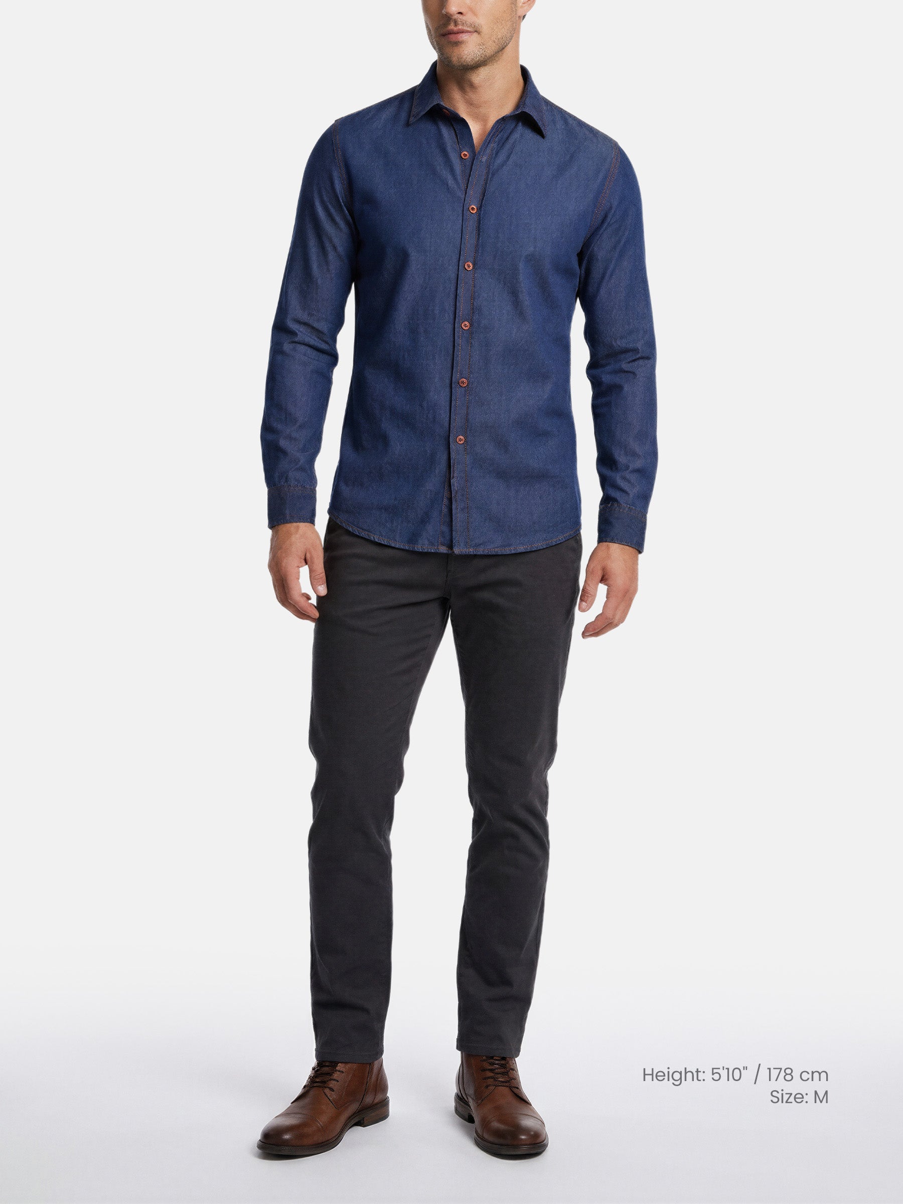 Model wearing navy tailored fit shirt styled with dark trousers and brown shoes