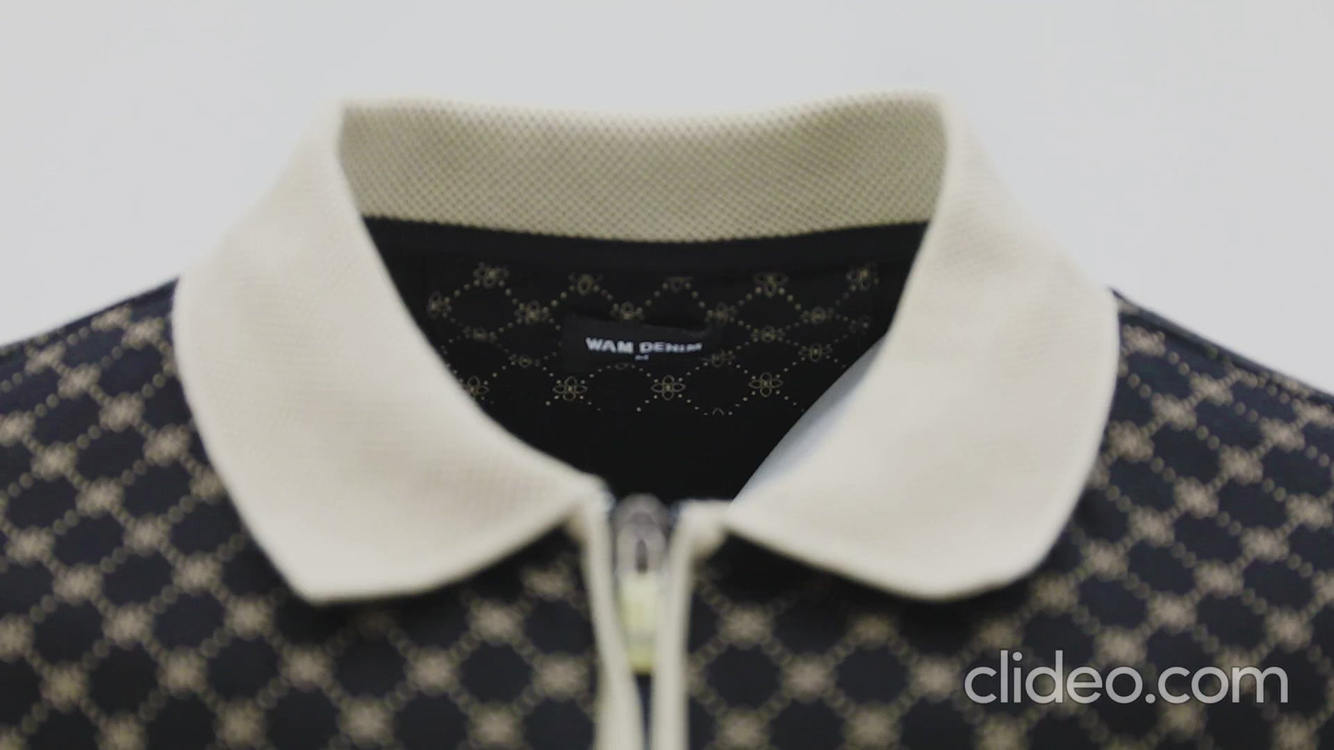 Black and beige patterned polo shirt with zipper collar turning under studio light, showcasing fabric texture and premium fit – Wam Denim.
