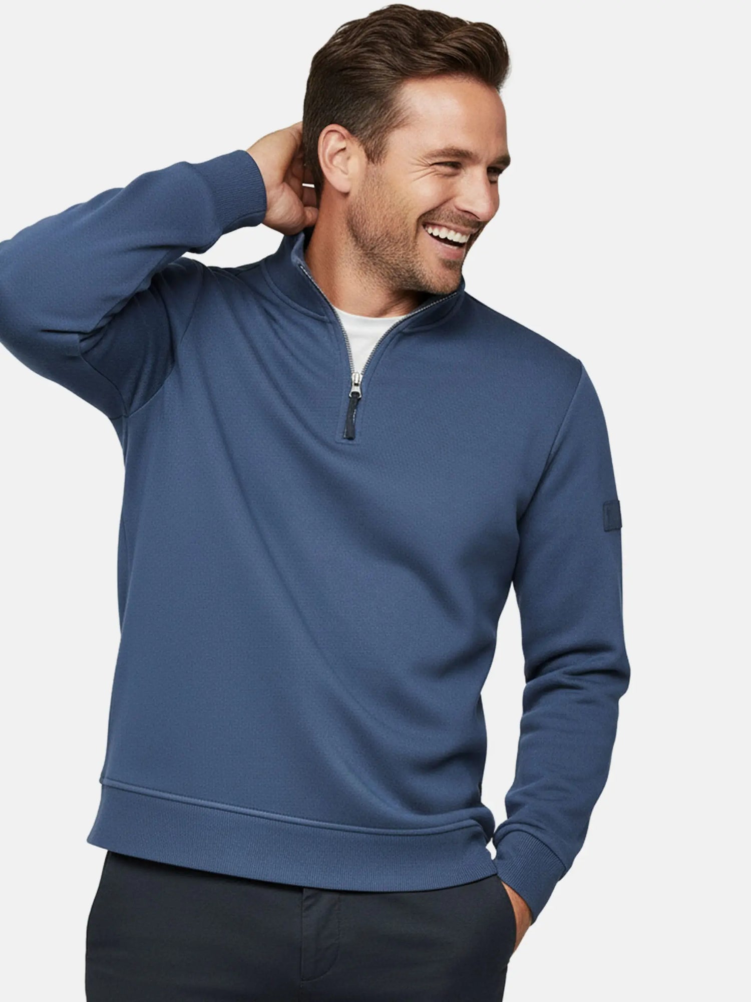 Close-up of model wearing indigo quarter-zip men’s sweater, Prime Indigo style.