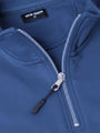 Close-up of indigo quarter-zip sweater showing zipper detail and smooth fabric.