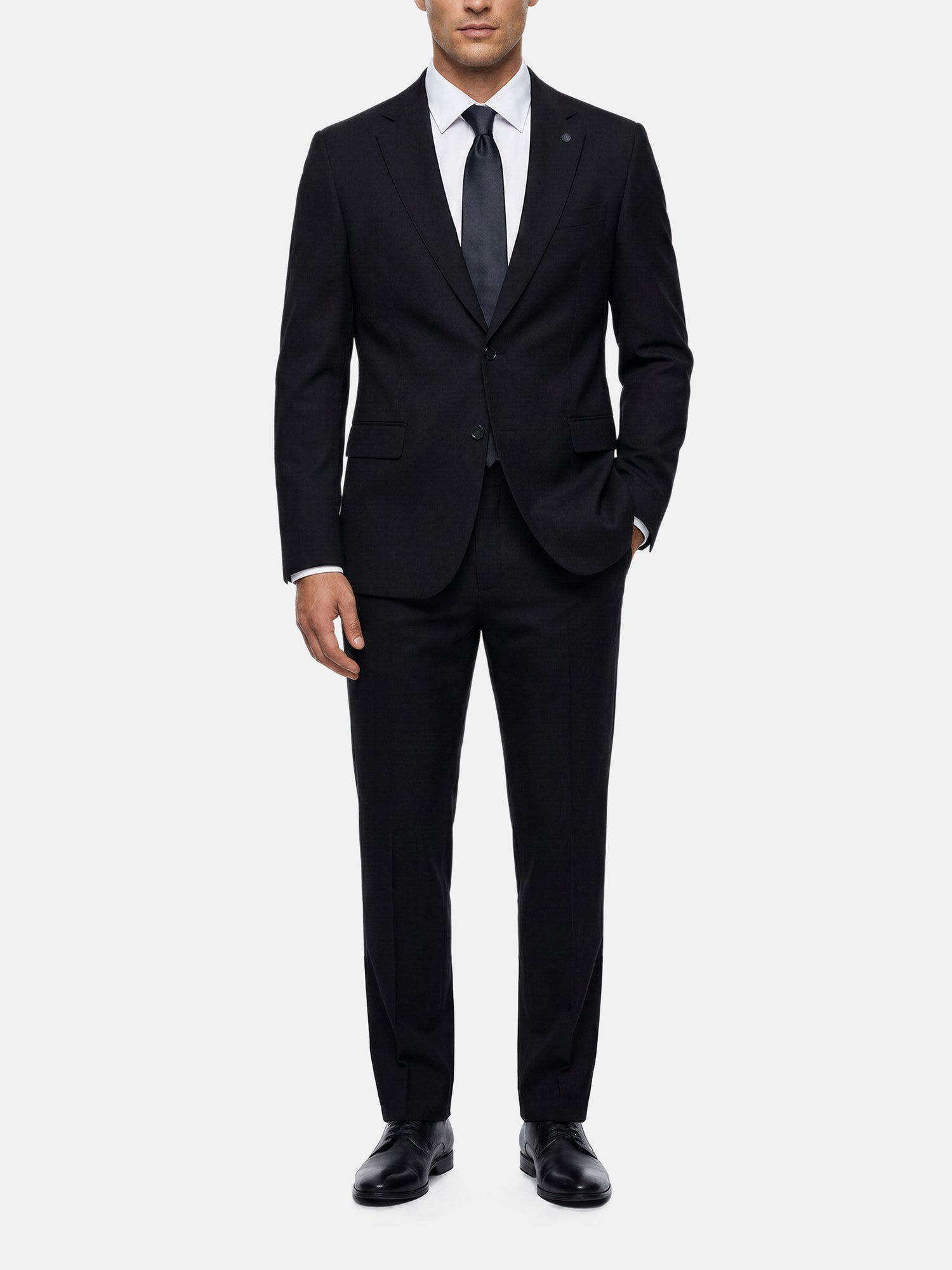 Men wearing black suit blazer with slim tailored fit, white shirt, and black tie.