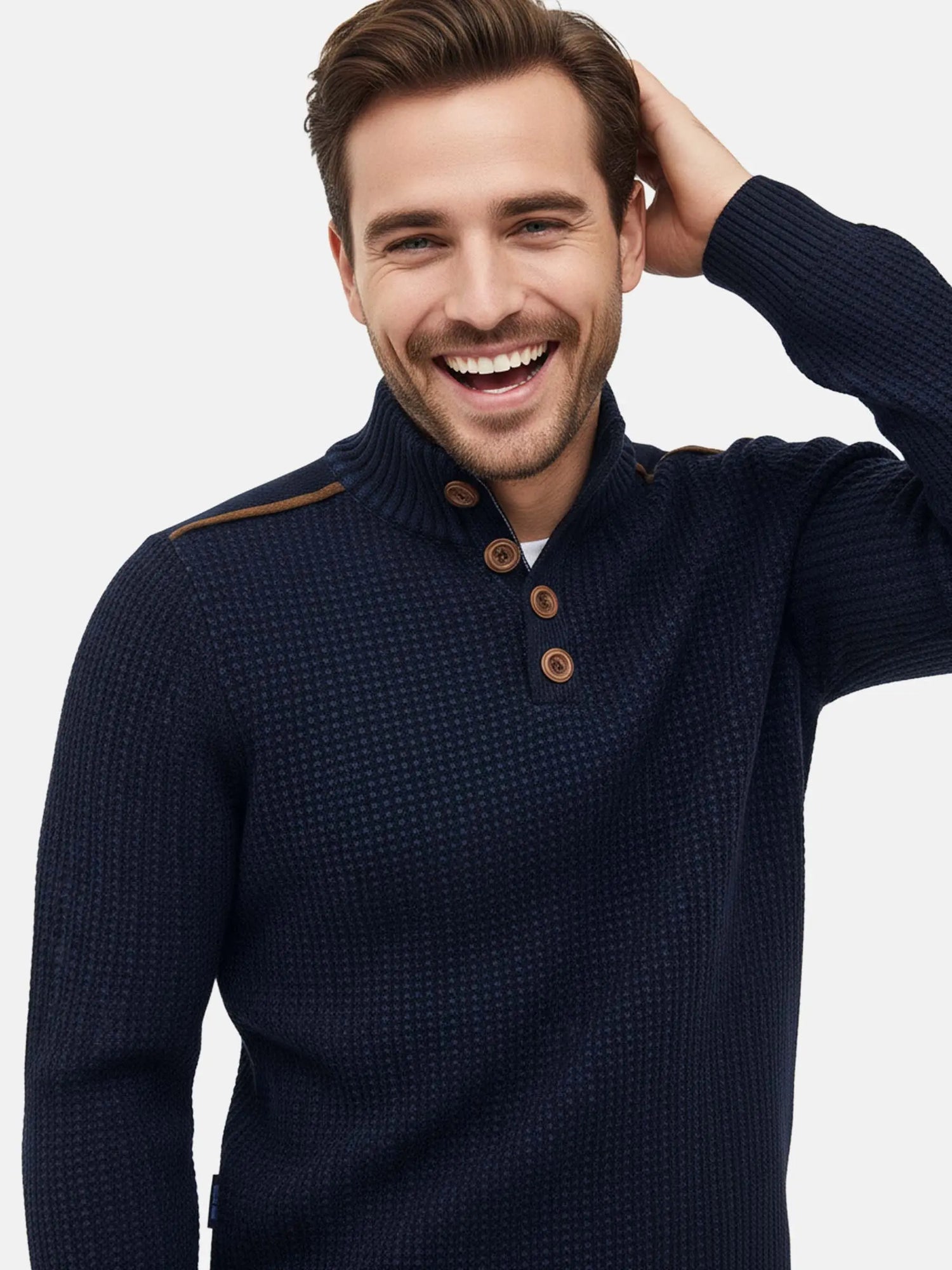 Close-up view of a man wearing an indigo navy textured knit sweater with brown buttons.