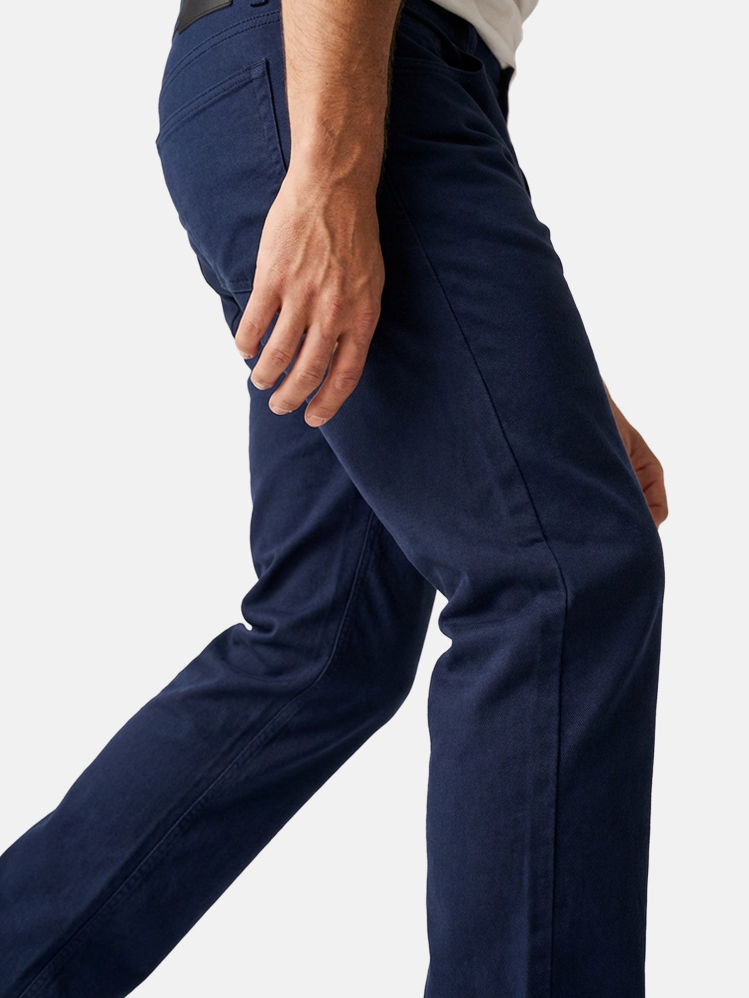 Close-up of men’s navy slim-fit jeans showing fabric texture and tailored fit