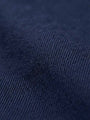 Close-up of navy denim fabric showing smooth weave and premium texture