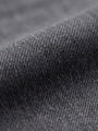 Close-up of grey denim fabric texture with fine weave detail.