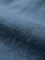 Close-up texture of blue stretch denim fabric.