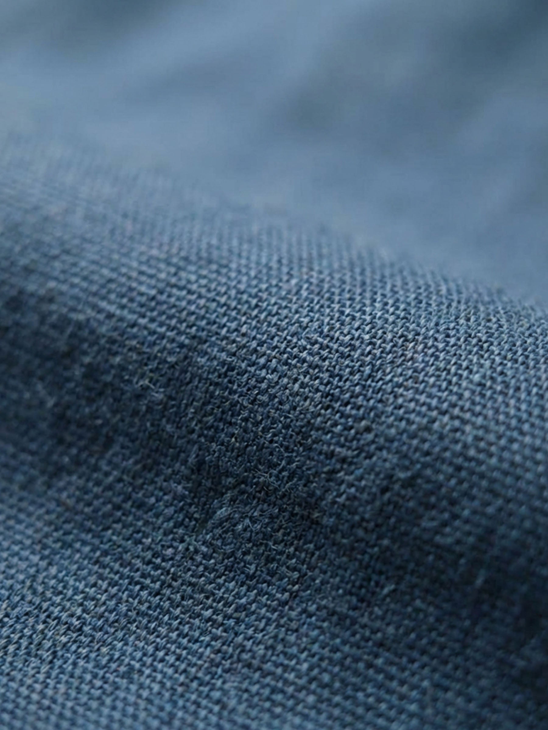 Close-up texture of blue stretch denim fabric.
