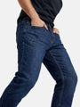 Close-up side view of blue jeans showing slim fit and stretch denim fabric