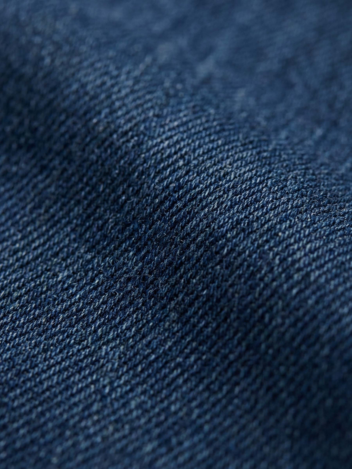 Close-up of blue denim fabric showing textured weave and durable finish