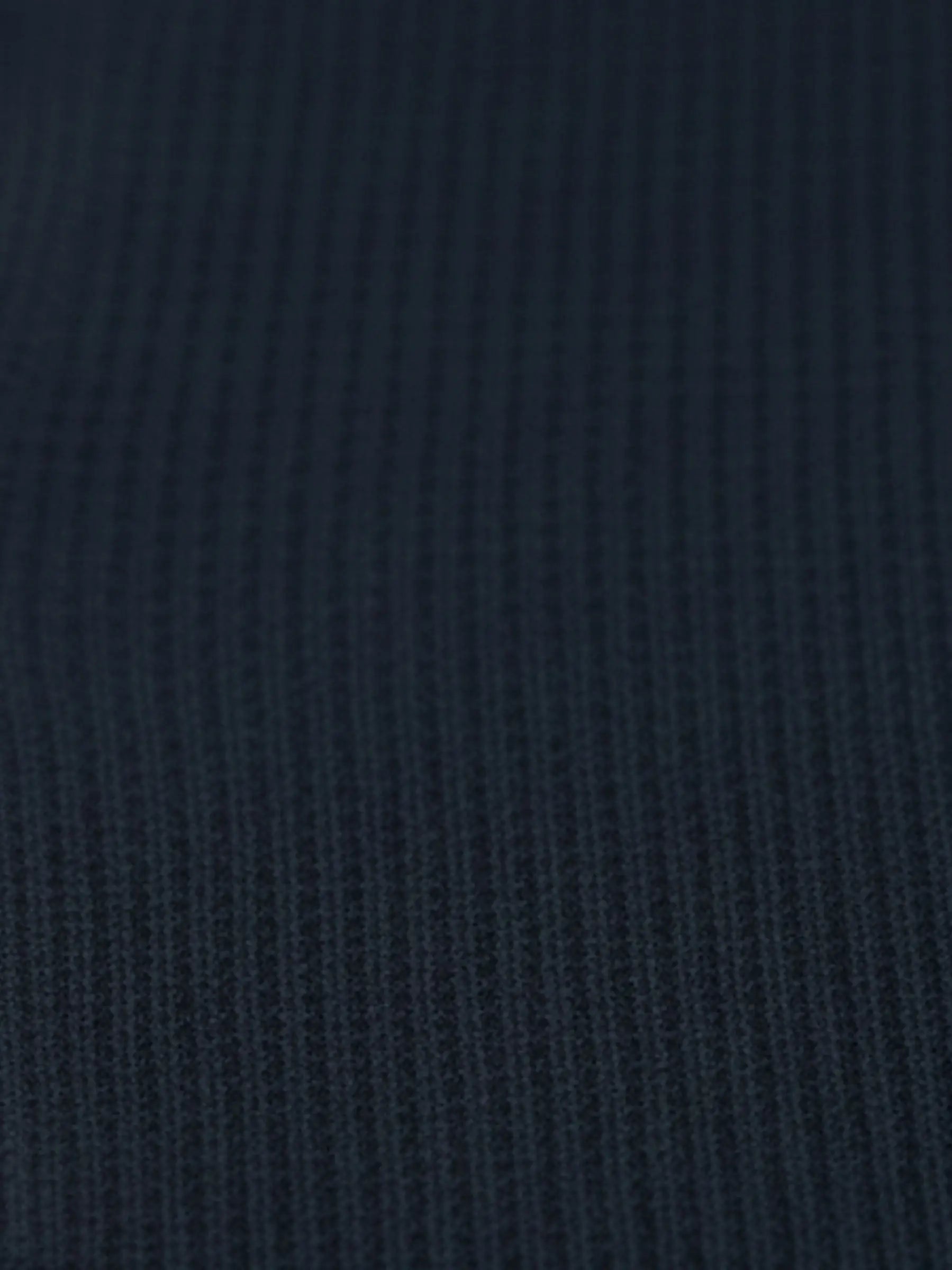 Close-up of navy textured knit fabric from the Zest Navy sweater.