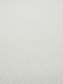 Close-up of off-white waffle knit fabric texture from the Zest sweater.
