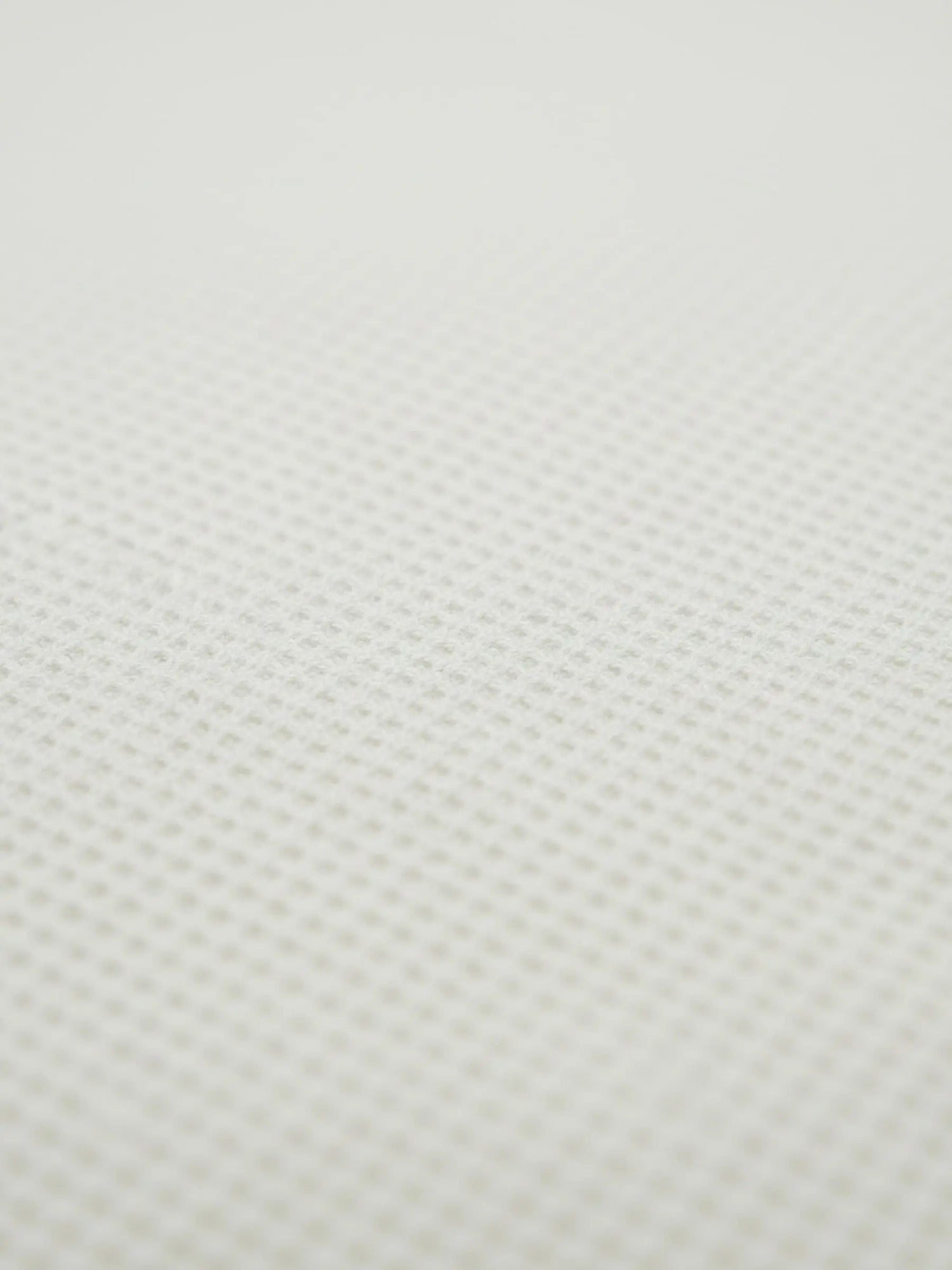Close-up of off-white waffle knit fabric texture from the Zest sweater.