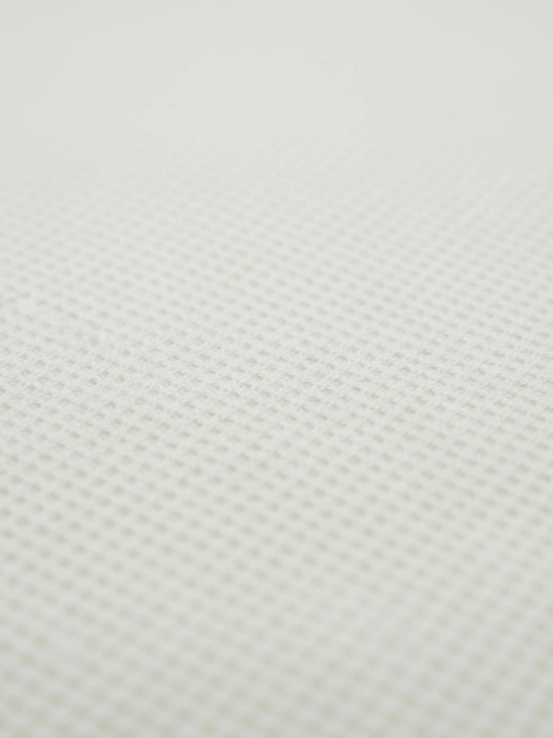 Close-up of off-white waffle knit fabric texture from the Zest sweater.